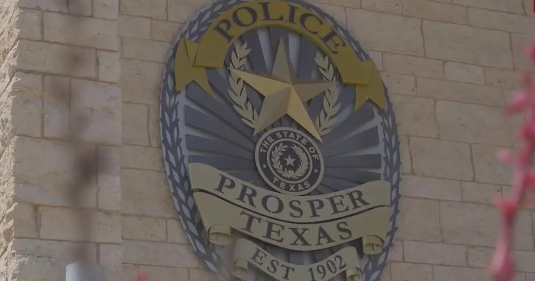 The Prosper Police badge cast in metal on a limestone wall.